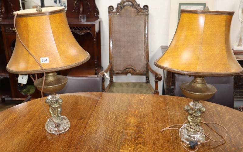 A pair of gilt metal cherub table lamps